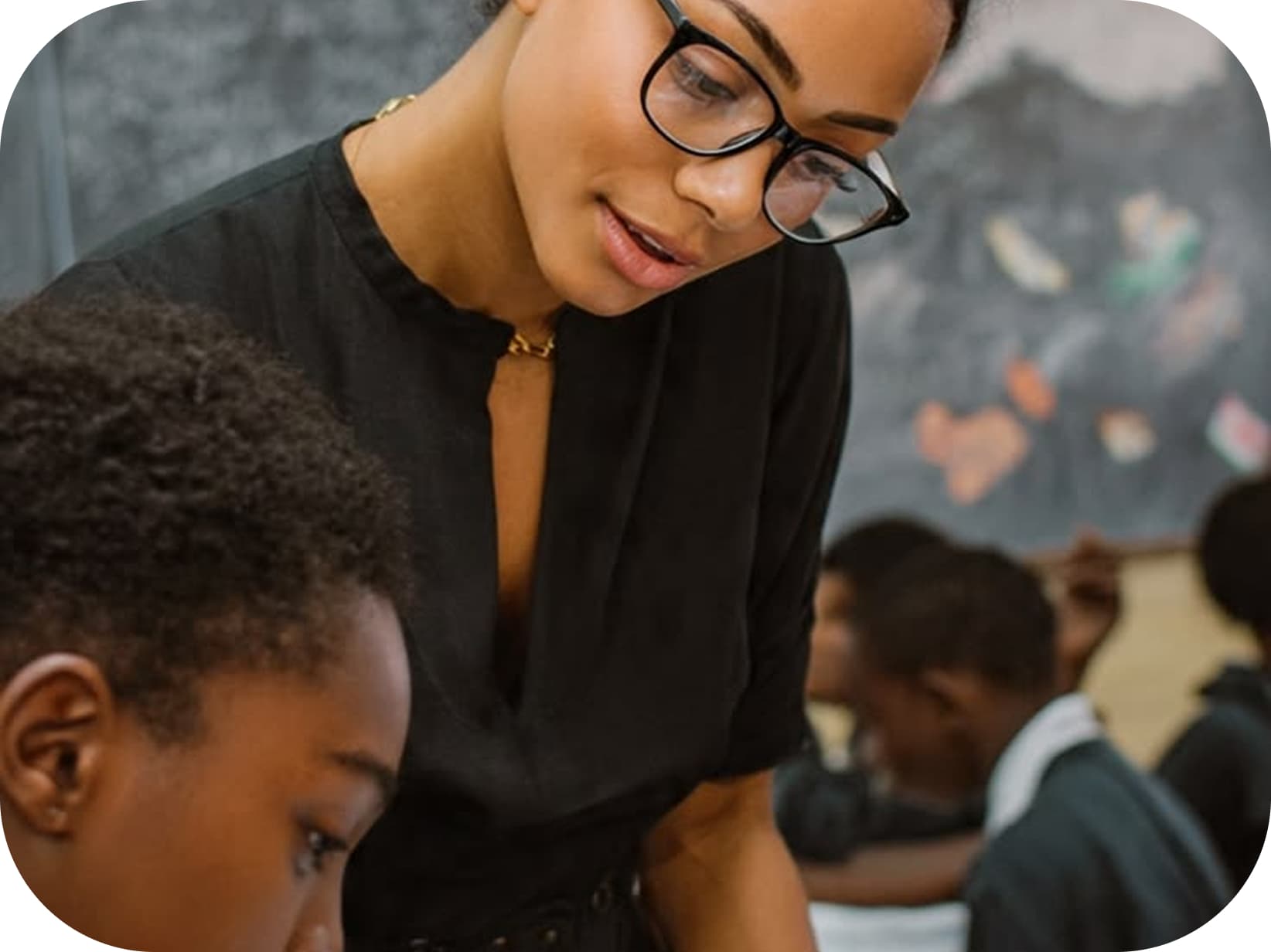 Teacher helping a student at a desk